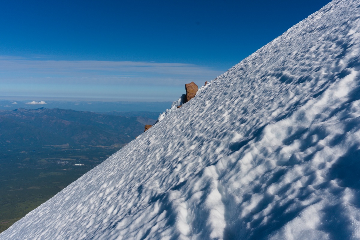 A view of the steep snowfield climb of the Mt. Shasta West Face nearing the top of the route.