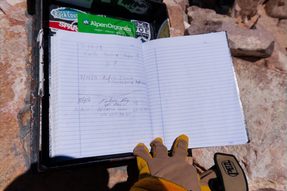 My climbing partner and I signed summit logged book.